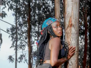 Woman wearing black top beside a tree