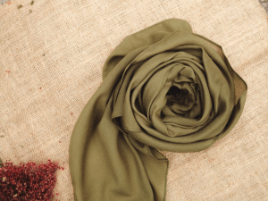 Silk scarf placed near flowers on table