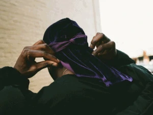 Man wearing purple durag