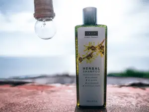 bottle of herbal shampoo with bulb beside