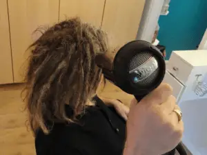 man using blow dry for dreads