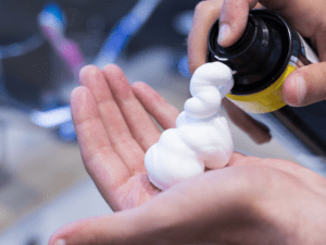 pouring shaving foam to hands