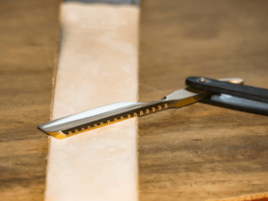 classic straight razor on a wooden background