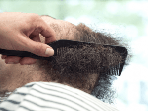 black man beard brushing