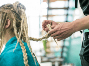 hairdresser styling woman locs