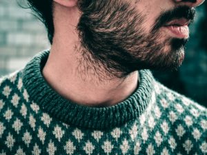 man wearing black and white knit sweater