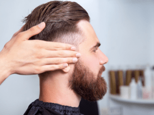 bearded man sitting in a barbershop