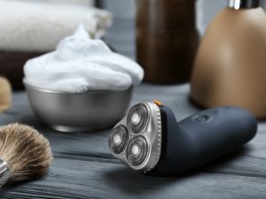 rotary shaver and shaving cream on table