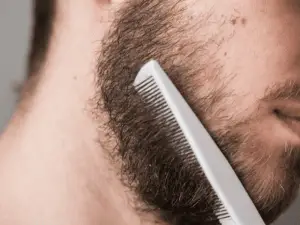 man combing his beard