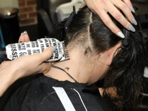 female getting a haircut with clippers