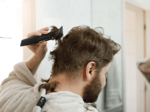 man shaving his hair