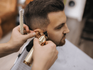 Hairdresser using a trimmer for hair cut