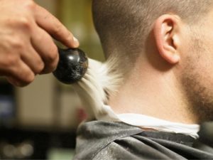 man using neck brush