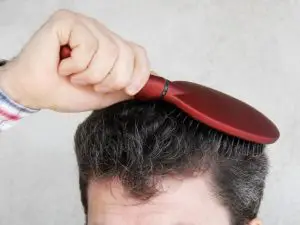 man brushing hair
