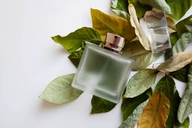 glass-perfume-bottle-with-green-and-yellow-leaves