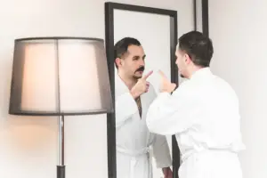 man talking to self in front of the mirror