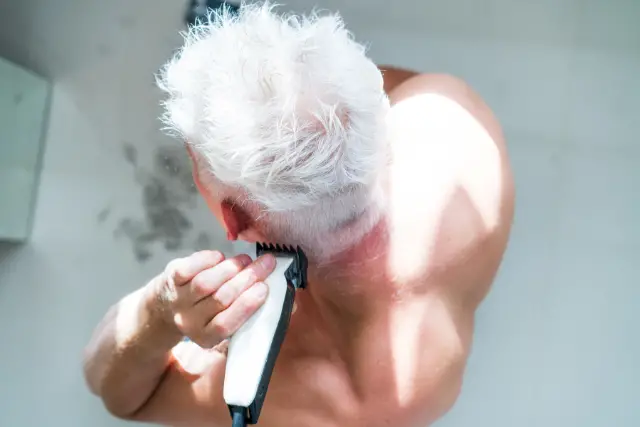 man trimming nape hair