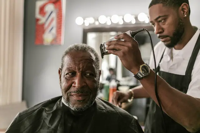 barber about to shave an old man's hair
