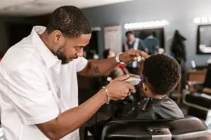 a barber using an electric razor - featured image