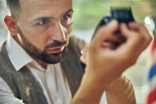 barber fixing his hair clipper