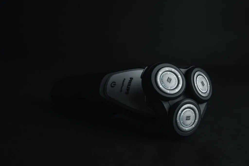 an electric razor on a black background