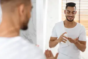 black guy pumping lotion on hand - featured image